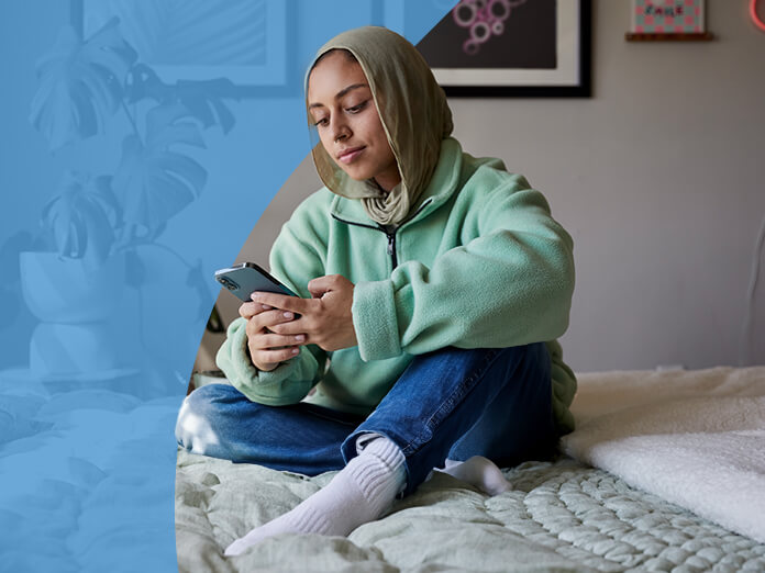 A woman checking her phone at home